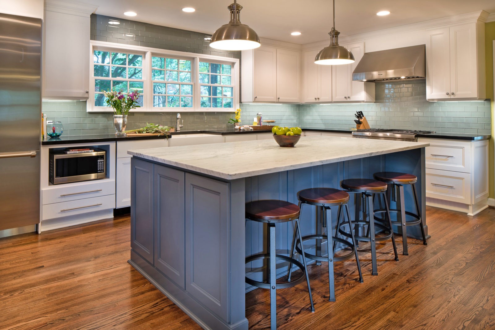Honed Carrara marble on this dark gray island creates a focal point in this Charlotte, NC kitchen remodel