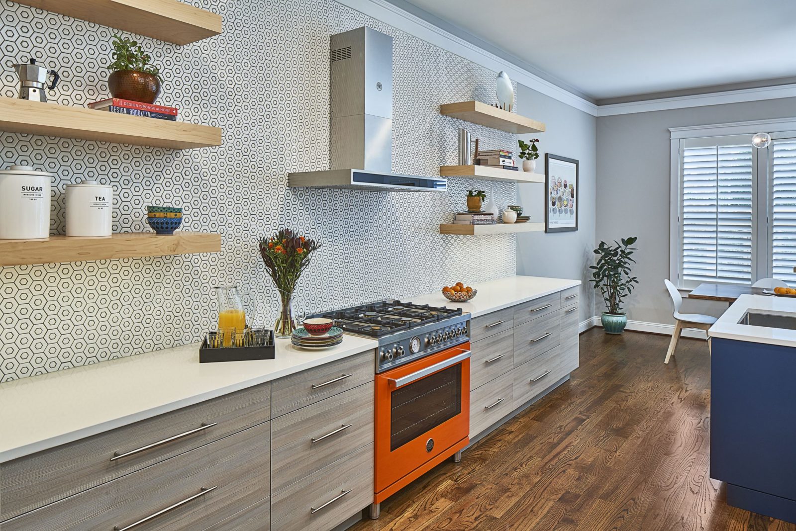 orange range in a modern kitchen with mosaic tile backsplash