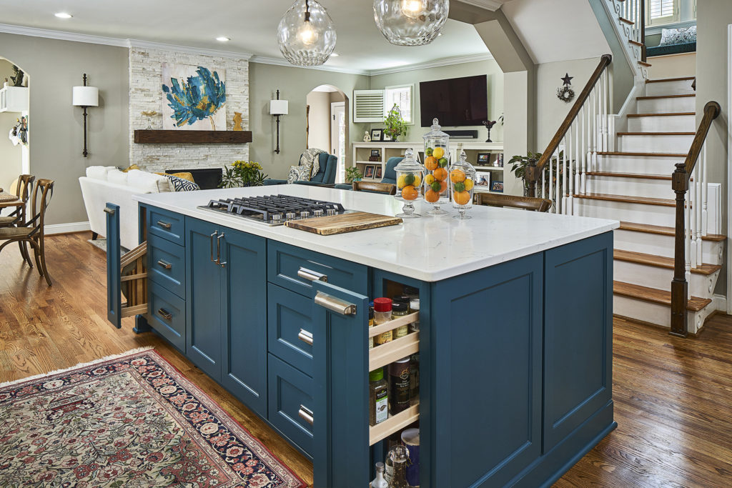 Custom-designed spice and tray pull outs in peacock green kitchen island
