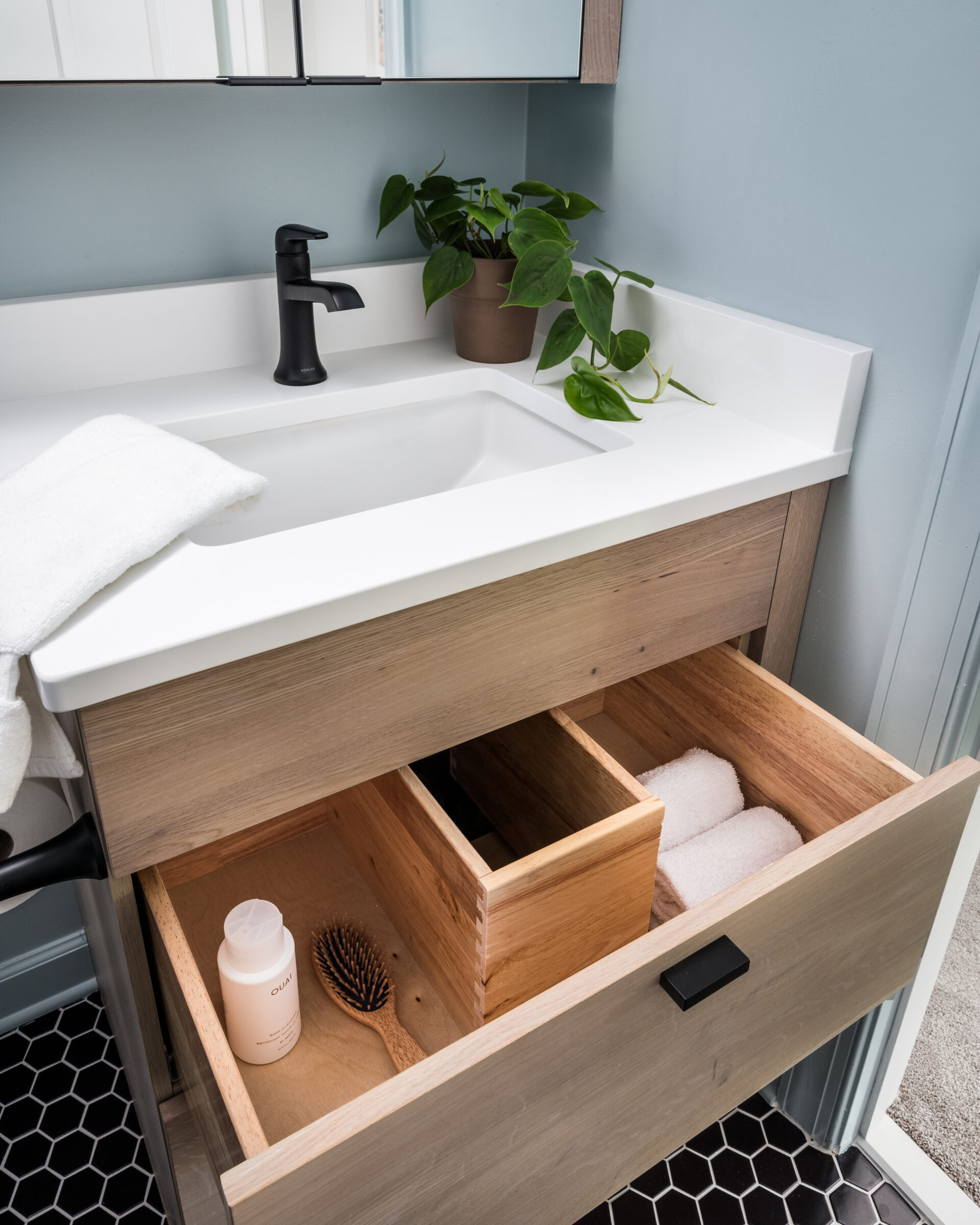 Minimalist bathroom sink with a sleek, U-shaped drawer featuring clean lines and a neutral color palette for a modern look.