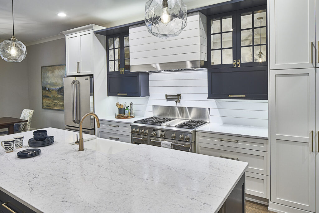 Modern kitchen with a hidden hood and stainless-steel appliances.