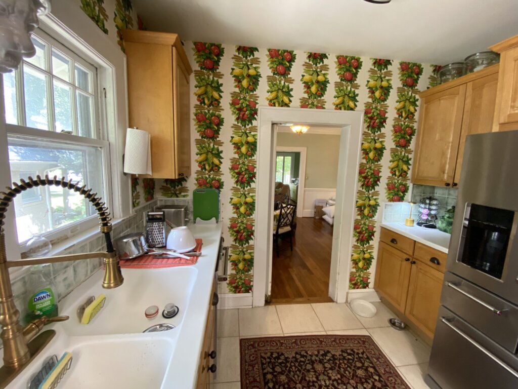 small kitchen with bold fruit wallpaper
