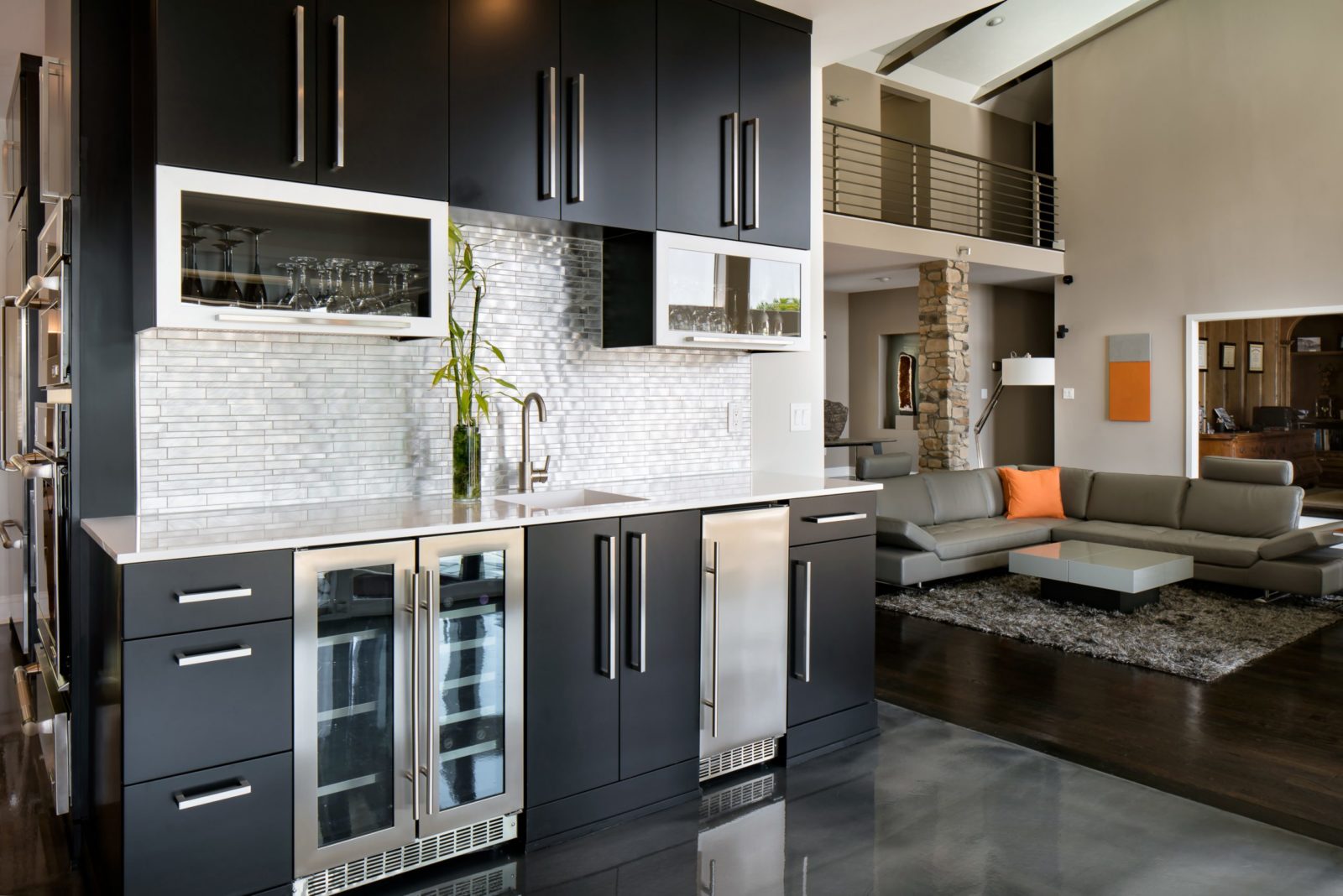Modern wet bar with black cabinets and ice maker
