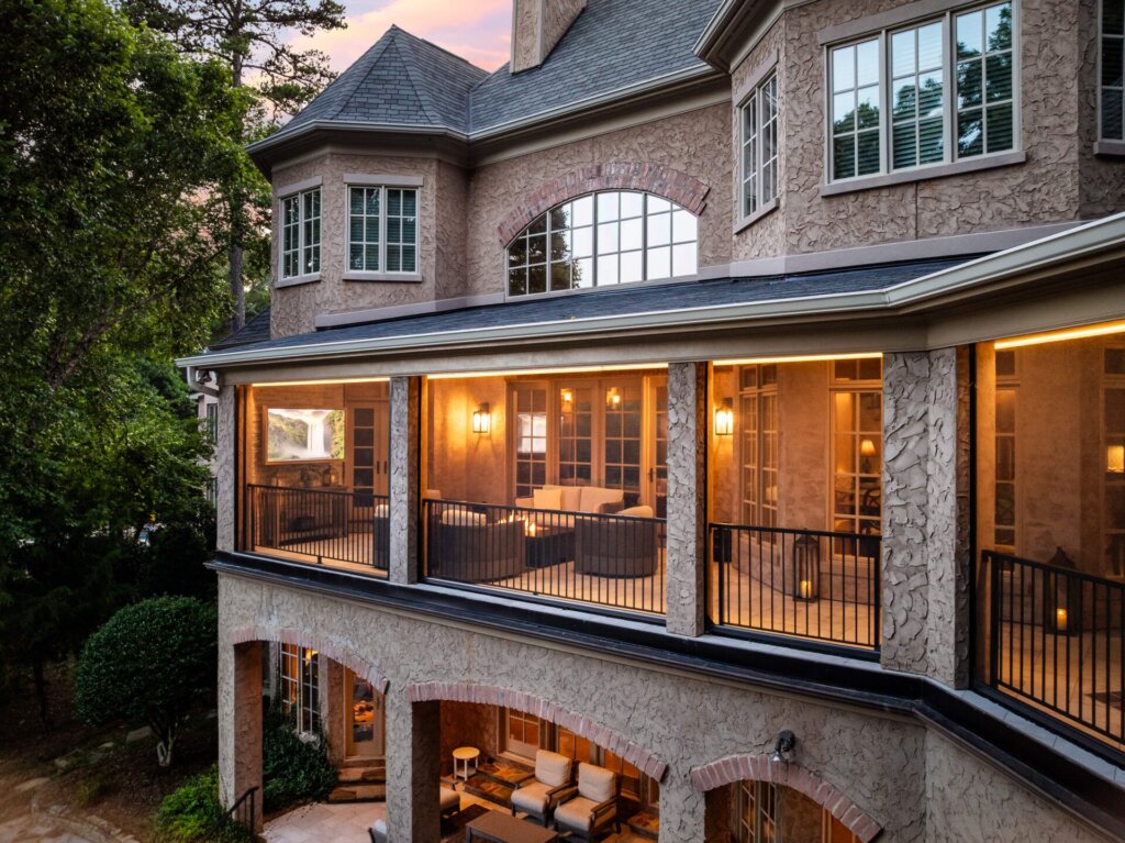 a second story porch remodel all lit up in the evening