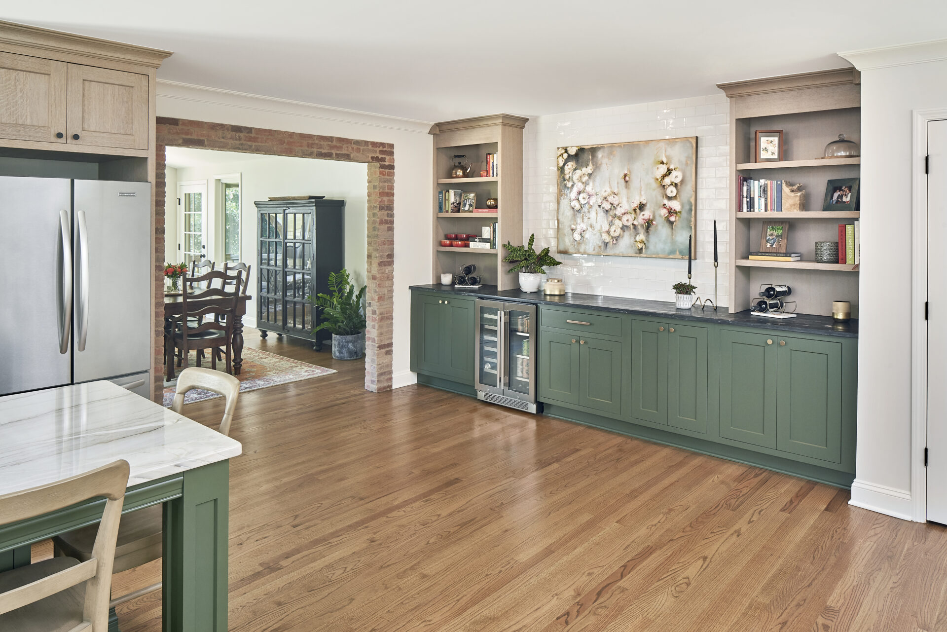 Darker moody kitchen with slim shaker cabinets, weathered quartersawn white oak, brick tile, and simpler moldings.