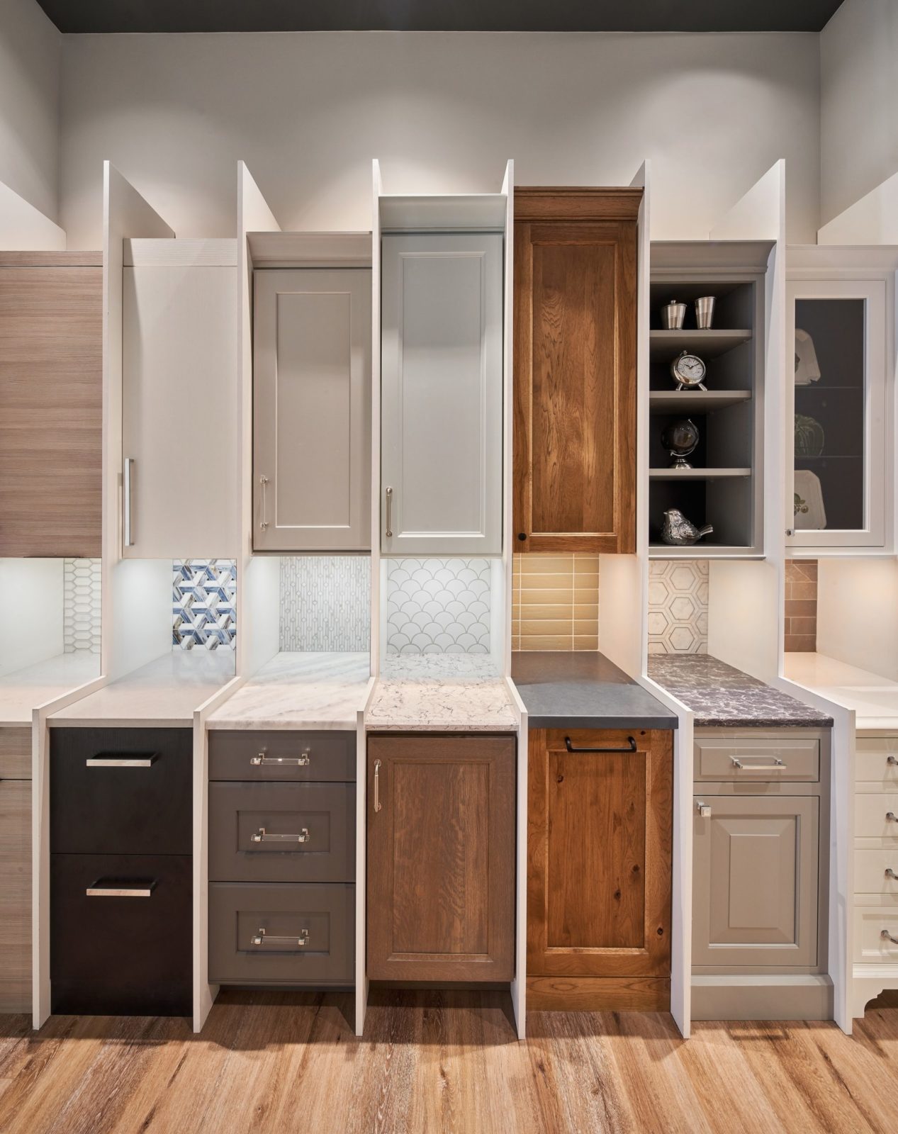 Miniature kitchen cabinet display with various door styles and finishes in our home design studio.