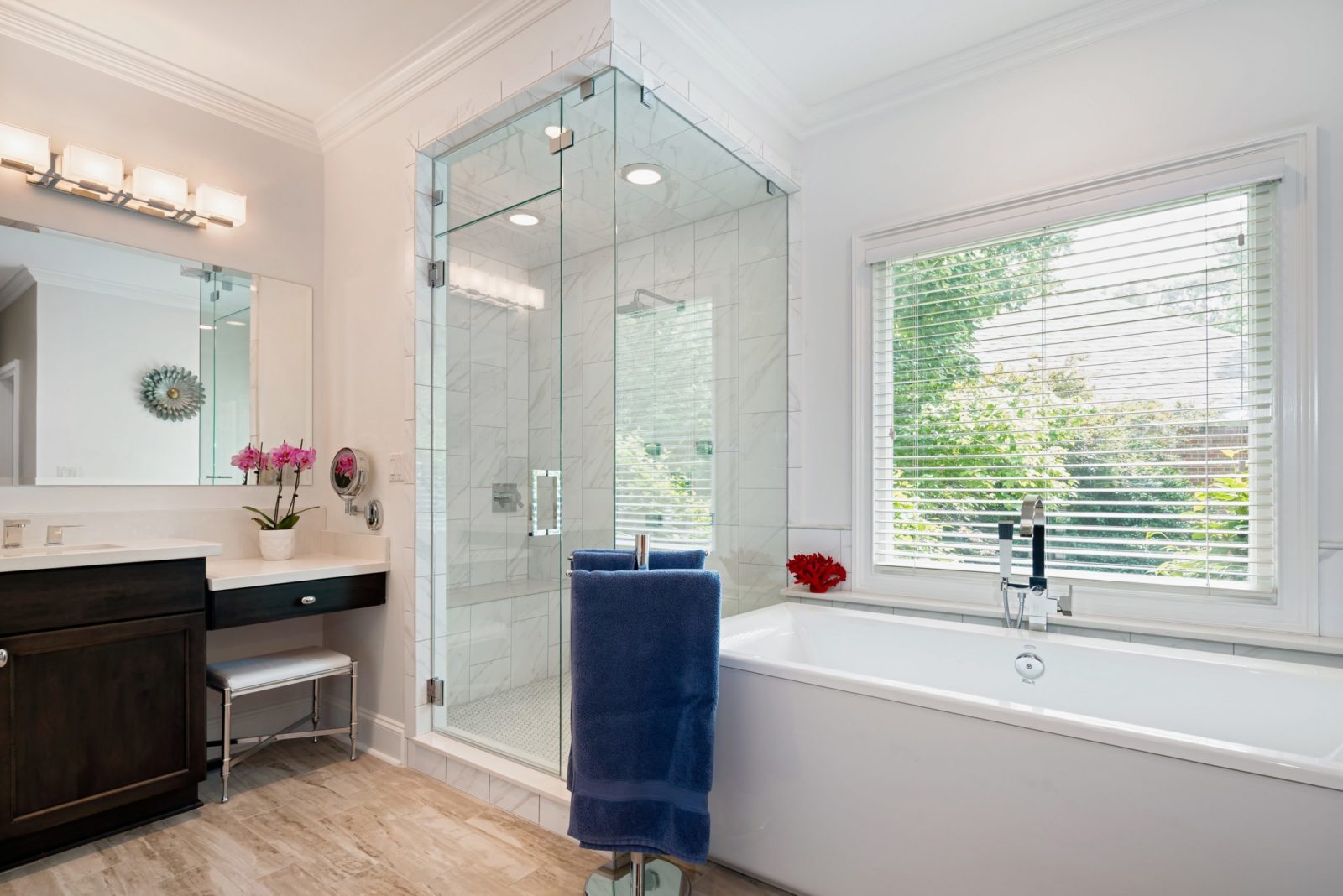 Steam shower with freestanding tub and dark stained vanity