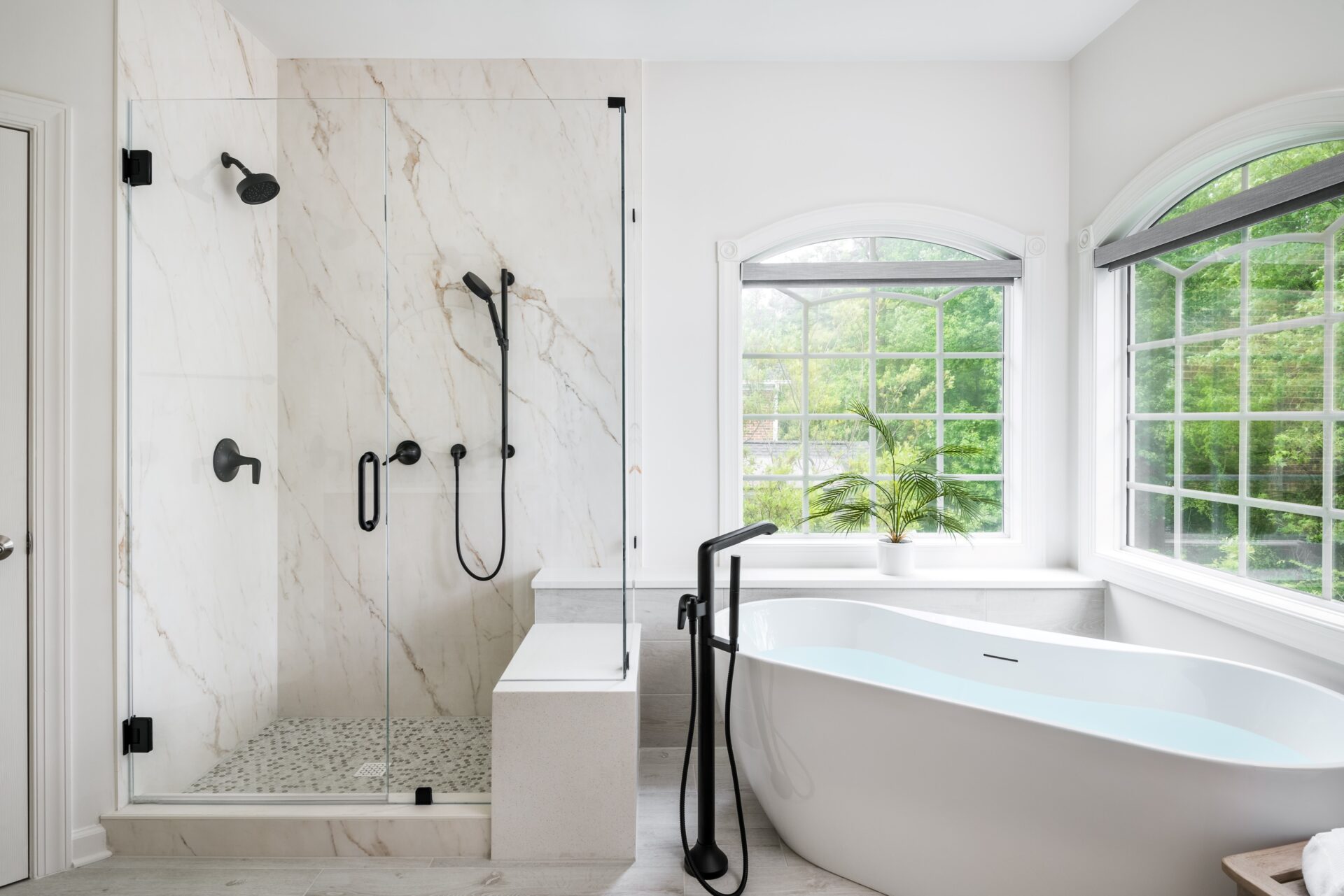 a walk-in shower alongisde a freestanding bath tub