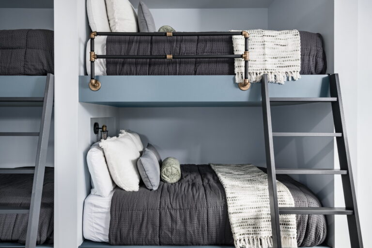 blue bunk beds with metail railings and wooden ladder