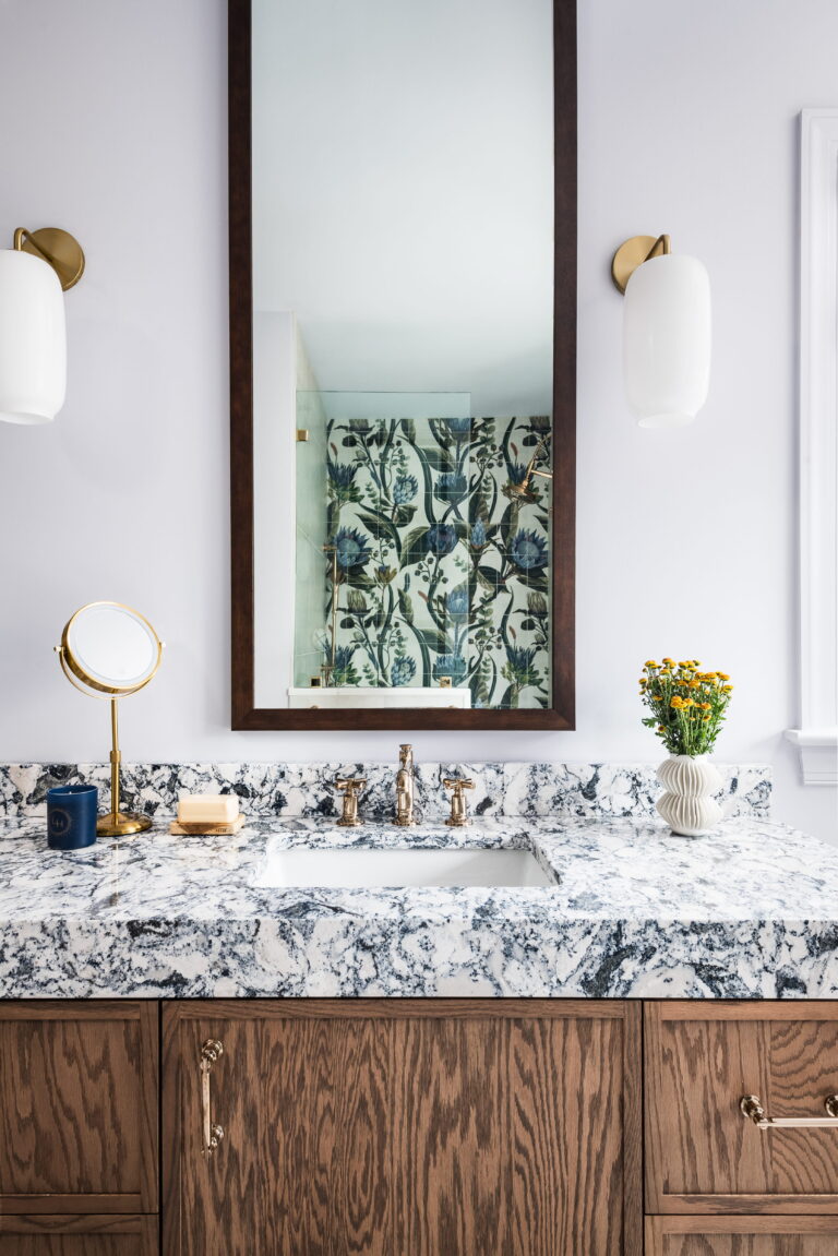 bathroom mirror reflecting the tiled shower wall